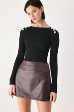 Brown faux leather skort with structured waistband seam and A-line mini silhouette