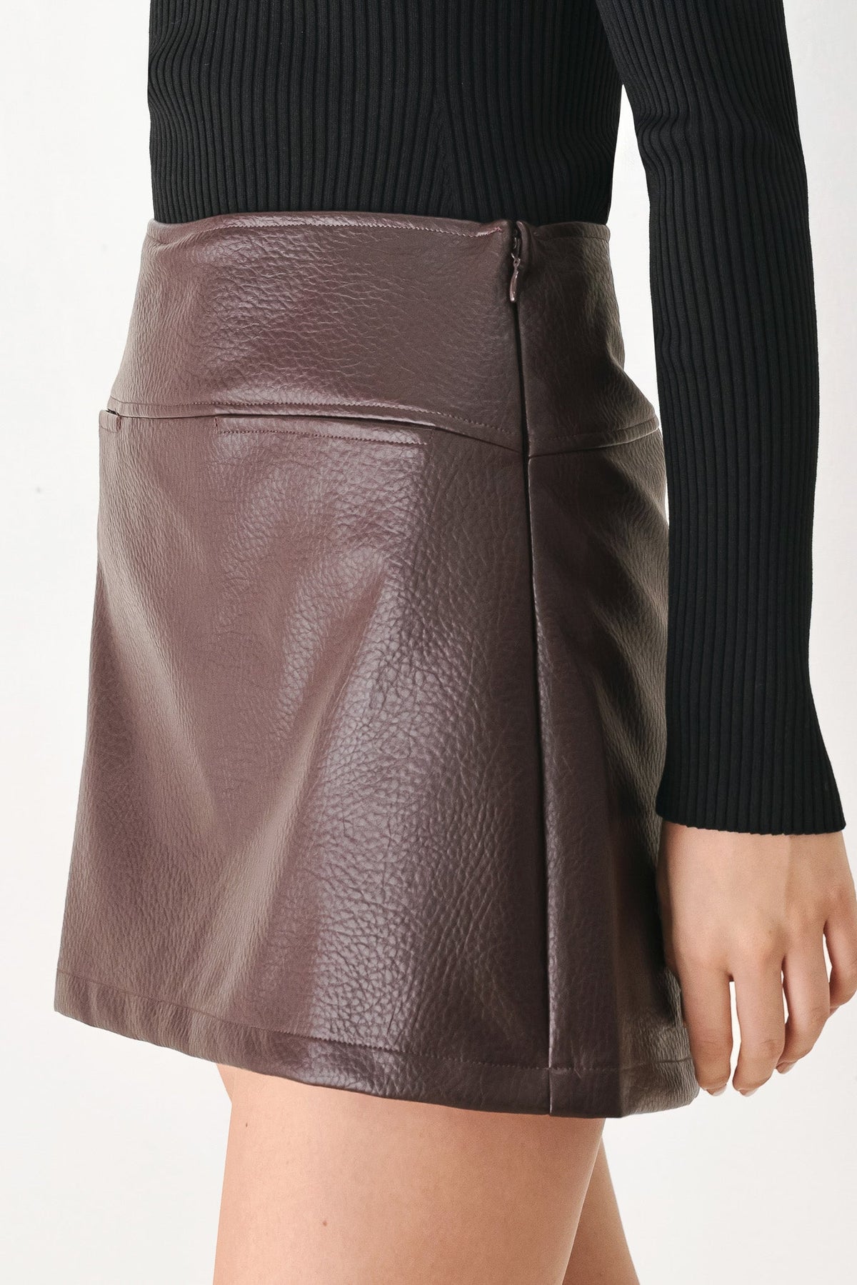 Brown faux leather skort with center front seam and visible side zipper seam