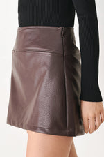 Brown faux leather skort with center front seam and visible side zipper seam