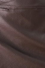 Brown faux leather texture detail with pebbled grain pattern