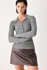 Grey ribbed knit polo top with pointed collar, button placket, and long sleeves.