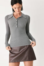 Grey ribbed knit polo top with button placket and pointed collar, long sleeves.