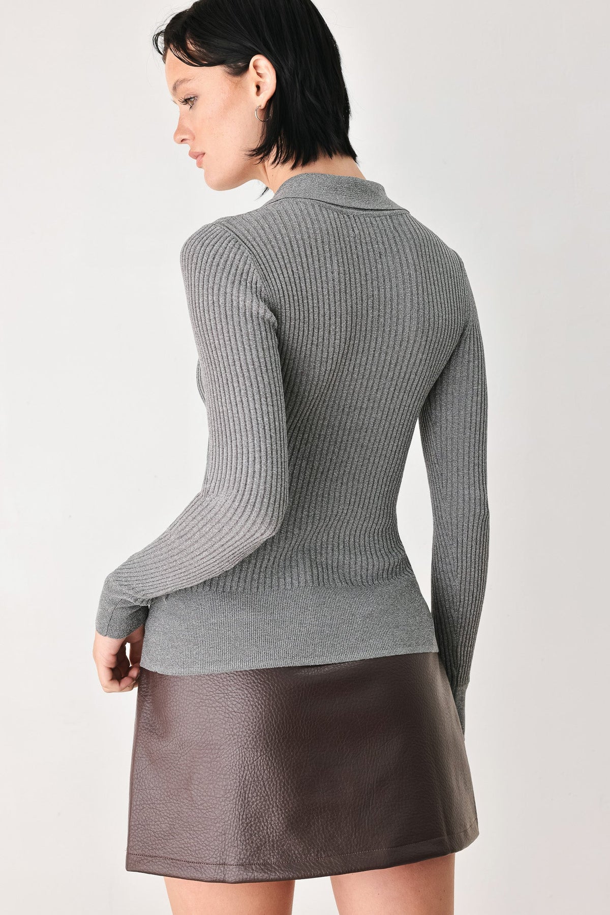 Grey ribbed knit polo top, long sleeves, and straight back hem.