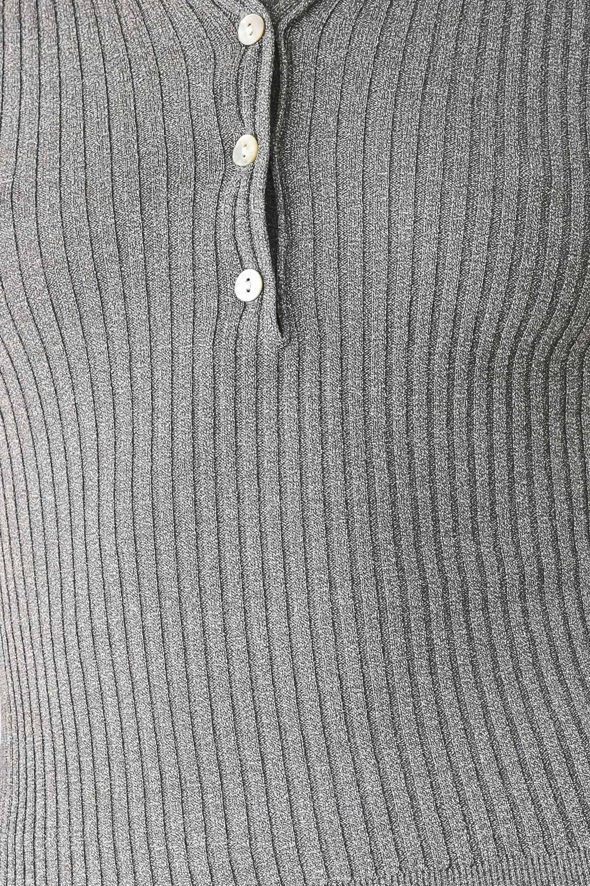 Close-up of grey ribbed knit polo placket with three buttons.