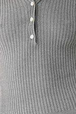 Close-up of grey ribbed knit polo placket with three buttons.