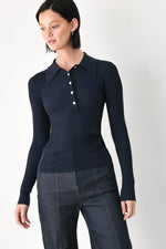 Navy ribbed knit polo top with pointed collar and button placket, long sleeves.