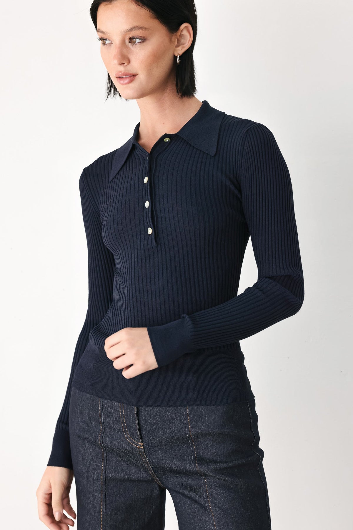 Navy ribbed knit polo top with long sleeves and three-button placket