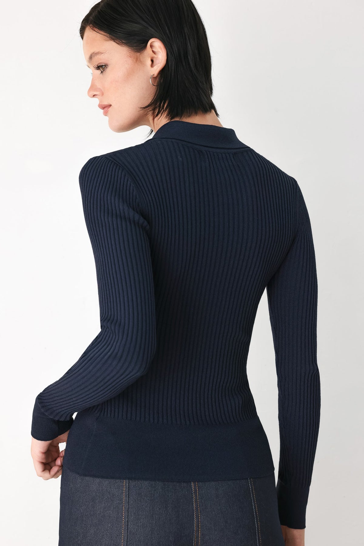 Navy long-sleeve ribbed polo top back view with fitted hem