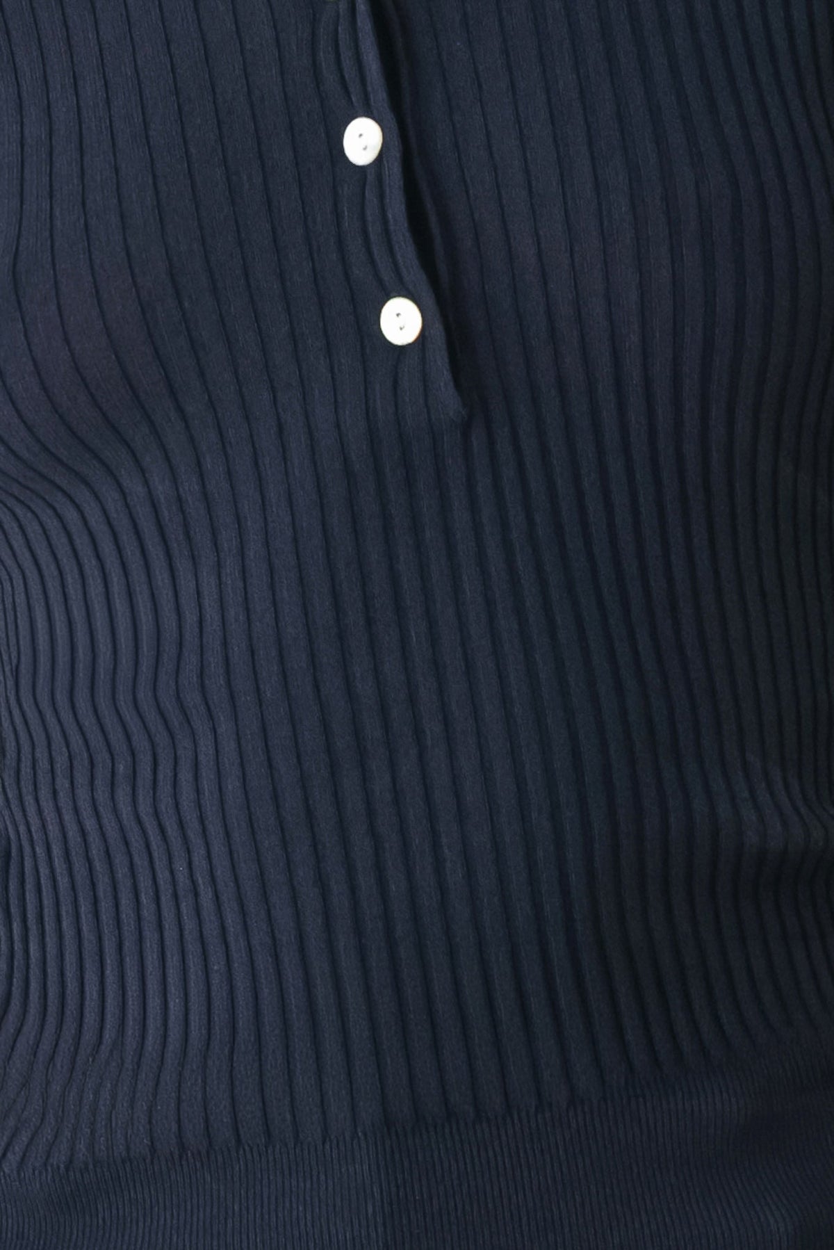 Navy ribbed knit polo fabric close-up with two white buttons