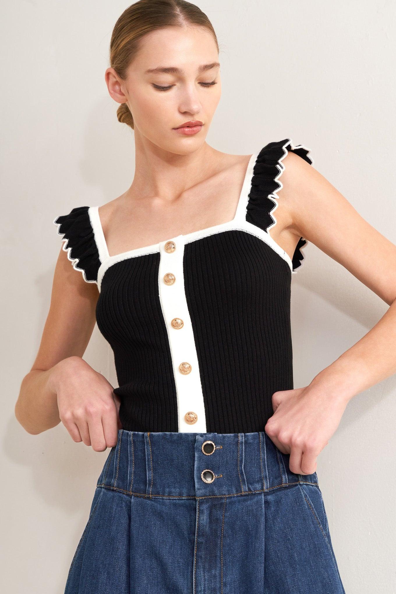 Black knit sweater top with white trim, square neckline, and front button placket