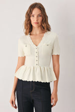 Off-white knit sweater top with front buttons, pocket detail, and peplum hem