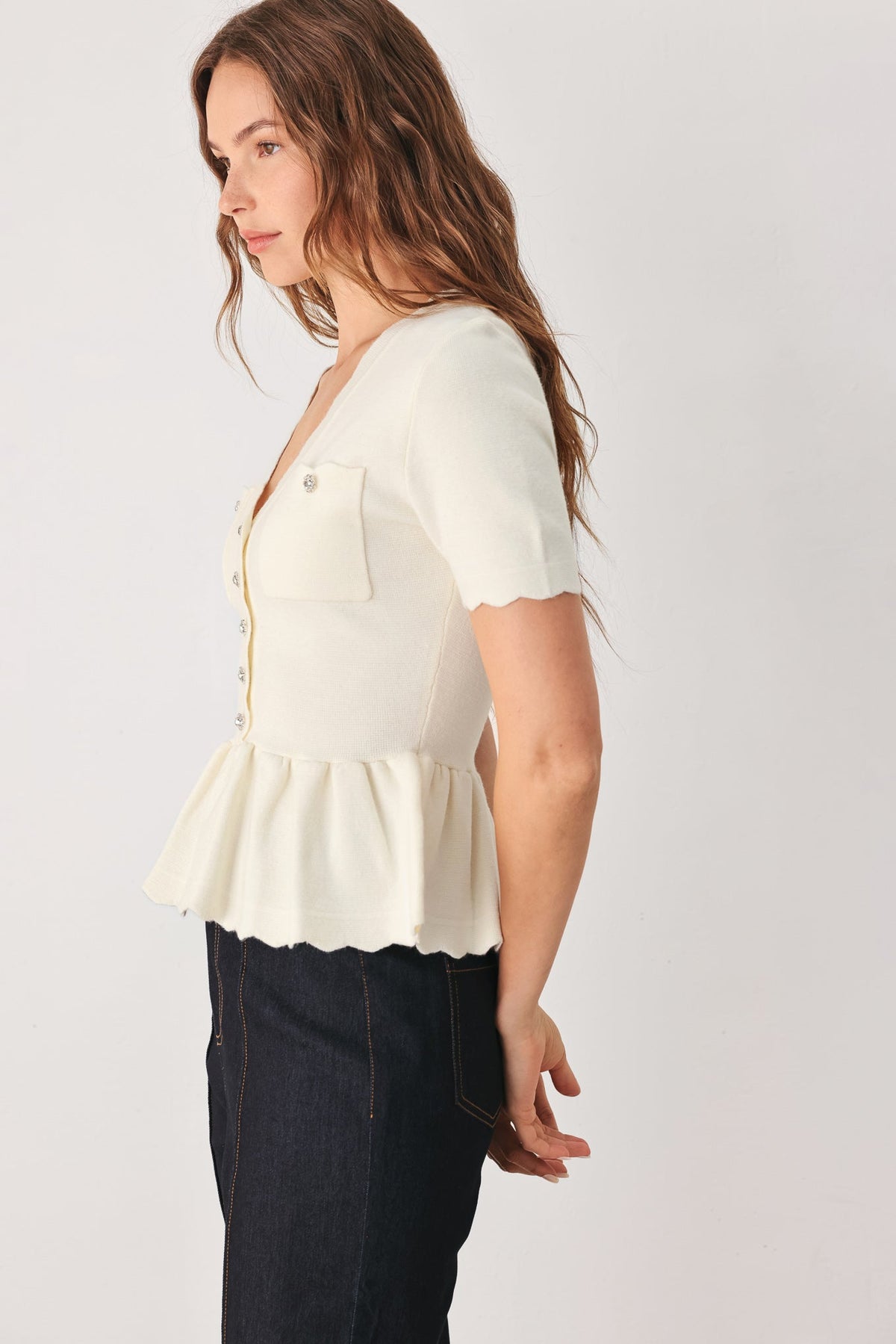 Off-white short-sleeve knit sweater top with peplum waist and front chest pocket