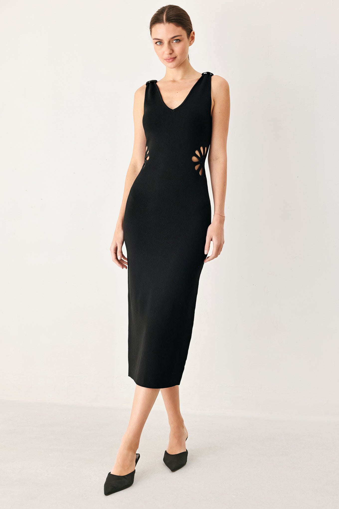 Black sleeveless knit midi sweater dress with V-neck and flower cutout accents