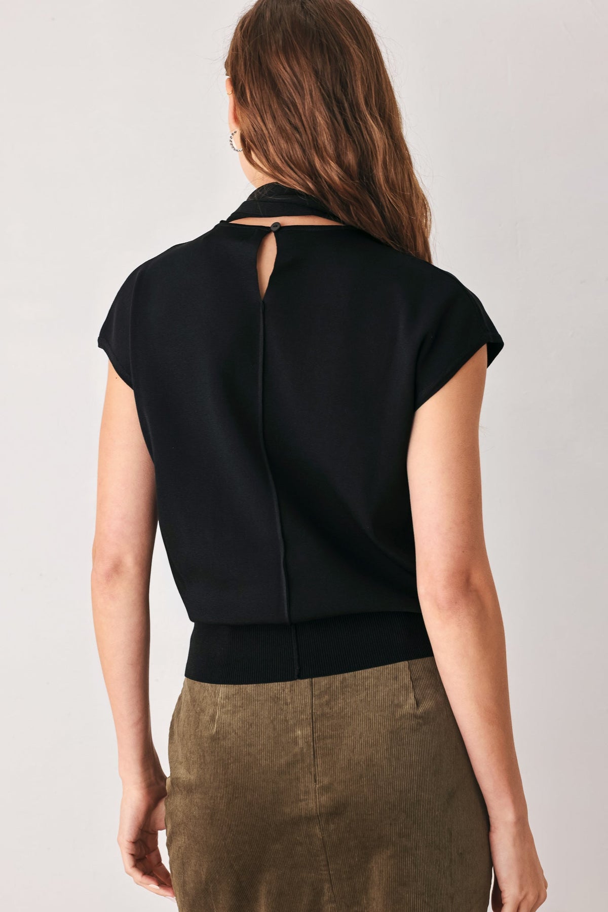 Black soft knit top with scarf neck tie, open back and short cap sleeves