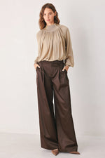 Taupe draped knit sweater top with long sleeves and relaxed gathered bodice