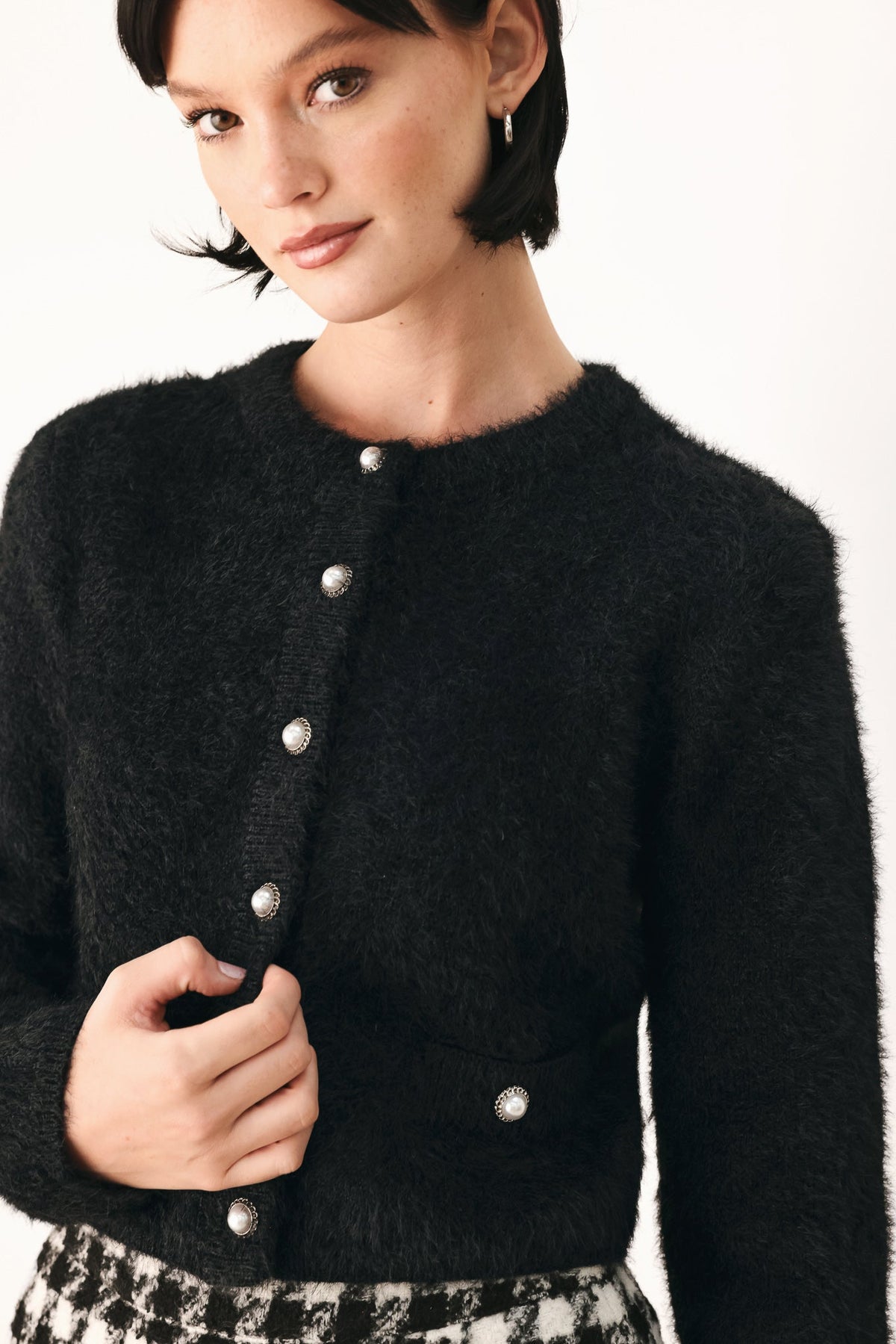 Black fuzzy cropped cardigan with button-front and oval metal-look snaps