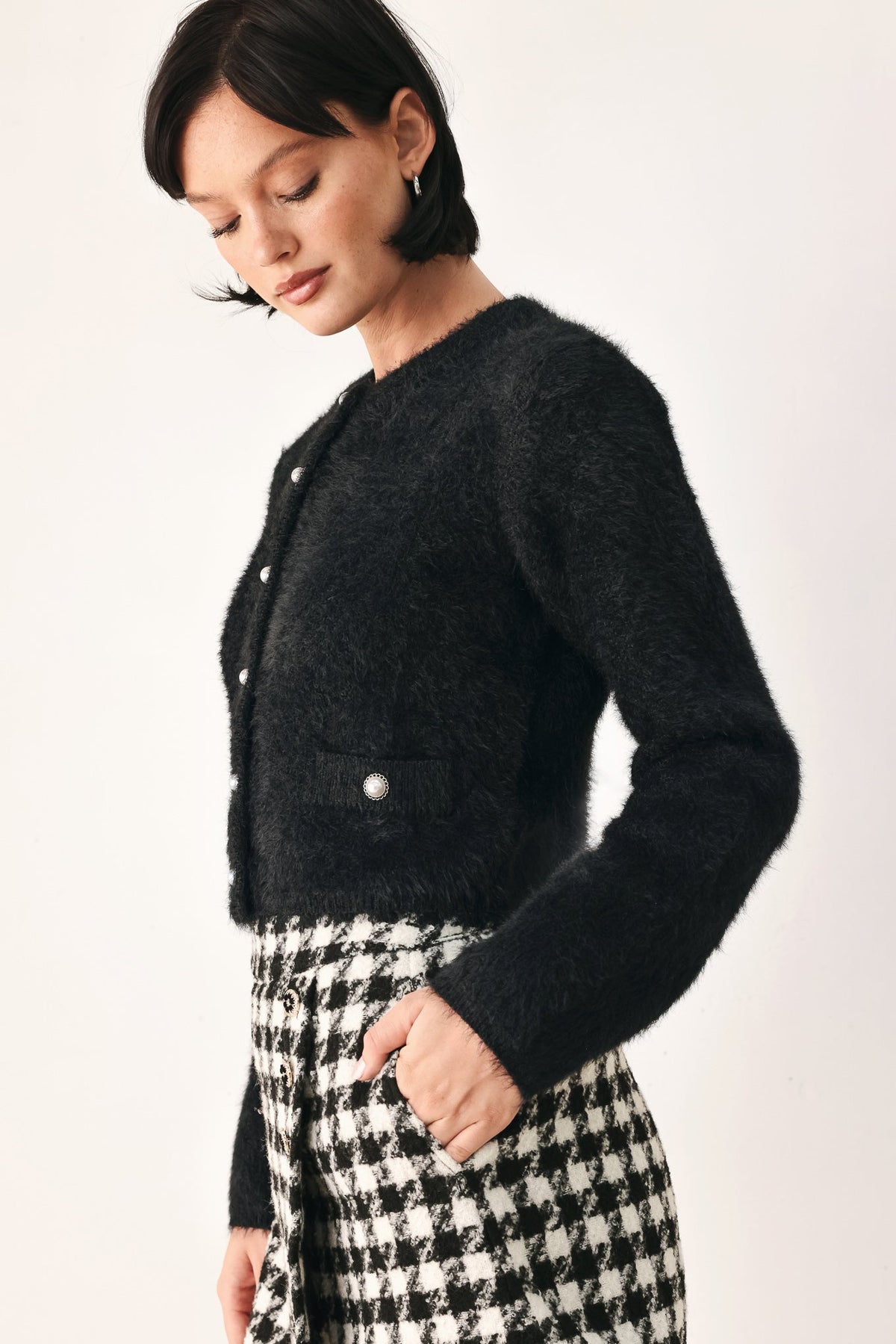 Black fuzzy cropped cardigan with button placket and long sleeves