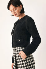 Black fuzzy cropped cardigan with button placket and long sleeves