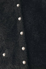Black fuzzy cropped cardigan close-up of oval silver-tone front buttons