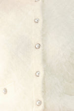 Ivory fuzzy cropped cardigan close-up of round button placket