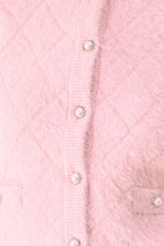 Pink cropped cardigan with three button closures on front placket