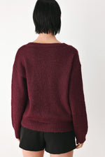 Burgundy knit sweater with cinched back neckline and long sleeves