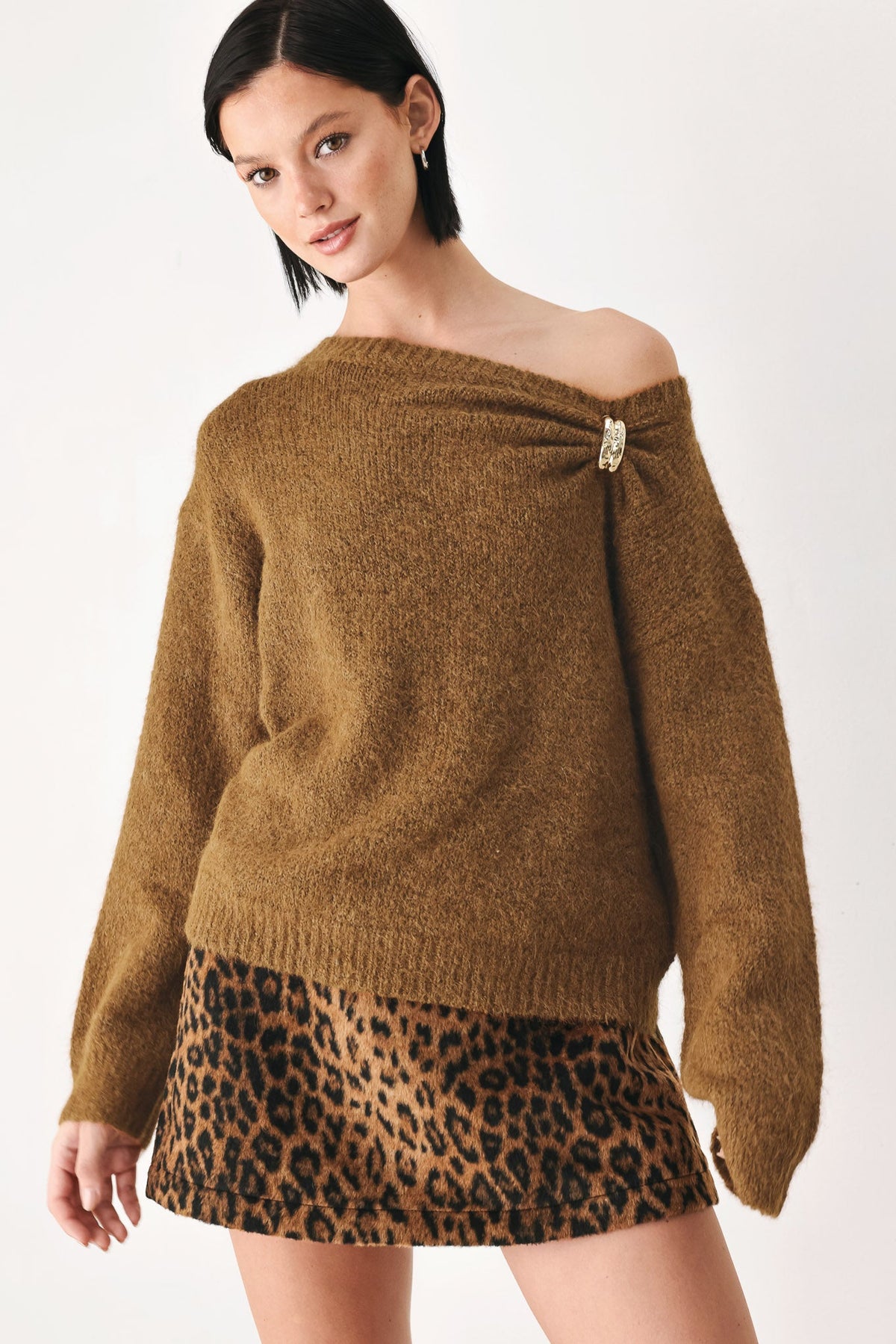 Camel-brown cinched neck sweater with off-shoulder neckline and clasp ornament