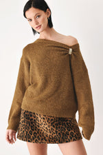 Camel-brown cinched neck sweater with off-shoulder neckline and clasp ornament
