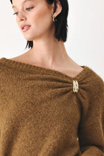 Camel-brown sweater featuring one-shoulder cinched neckline with clasp detail