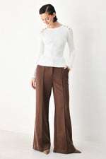 Off-white ribbed knit sweater top with long sleeves and crew neck