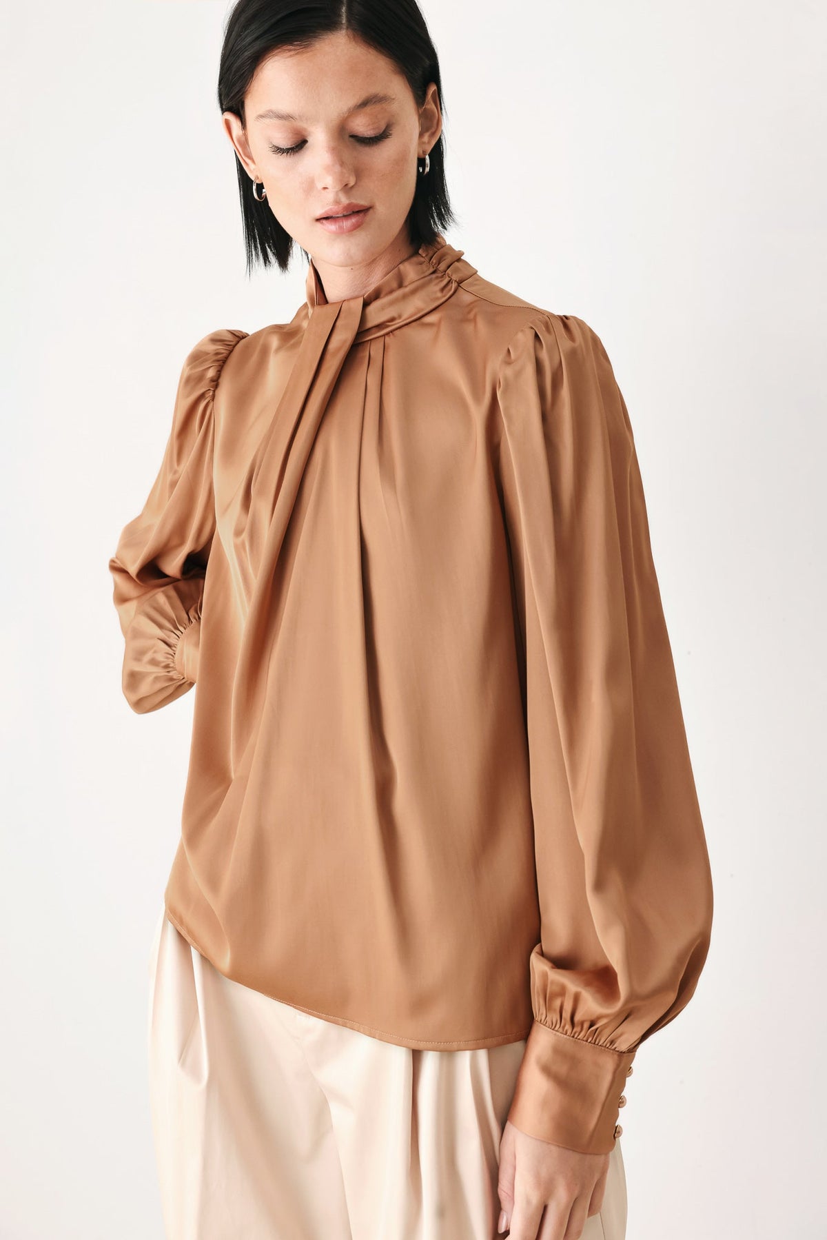 Bronze high-neck blouse with bow tie at collar and gathered long puff sleeves