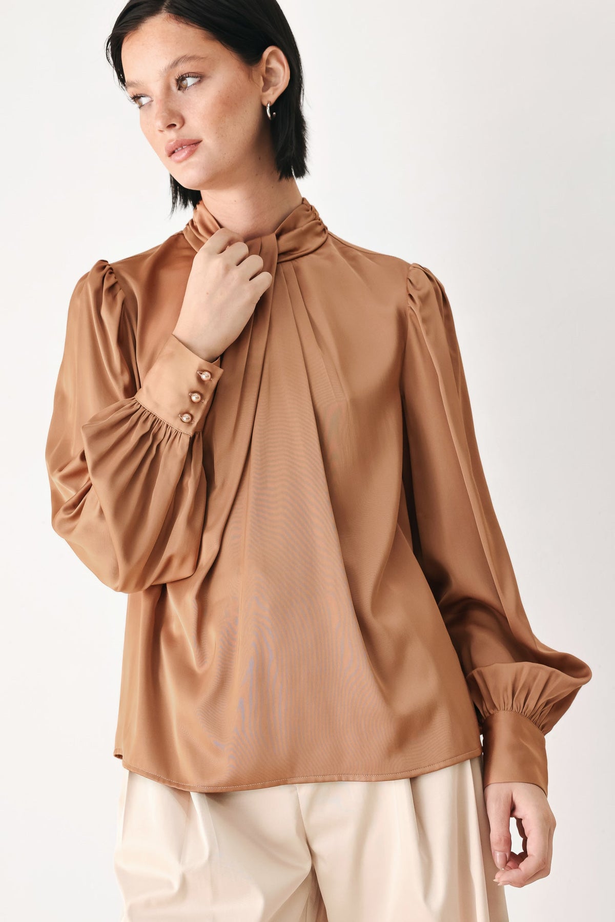 Bronze high-neck blouse with tied collar, gathered shoulders, and puff sleeves