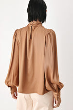 Bronze high-neck blouse back view with gathered shoulders and long puff sleeves