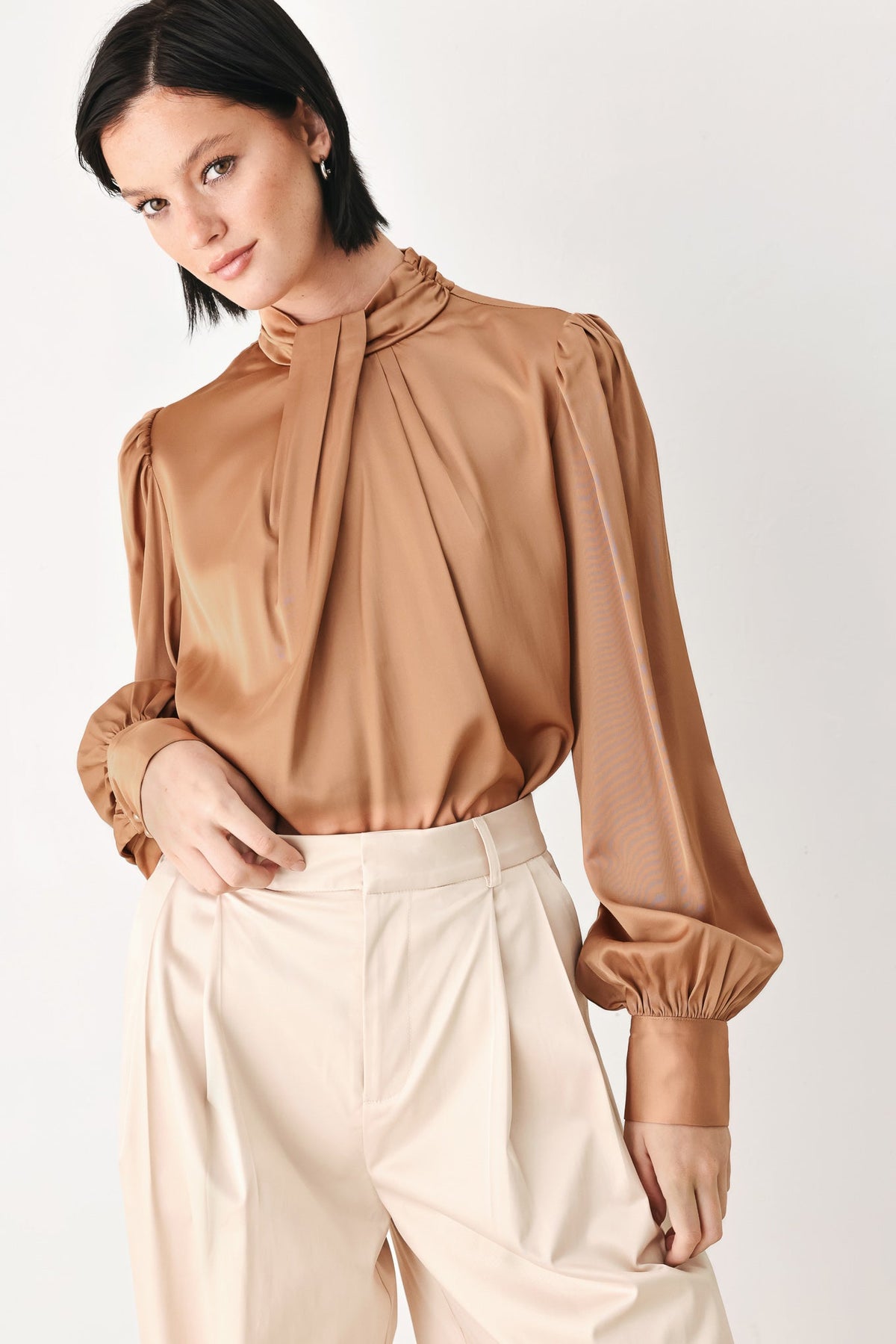 Bronze high-neck blouse with tied collar and flowing pleated front