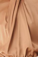 Bronze blouse fabric close-up with pleated panel and gathered neckline