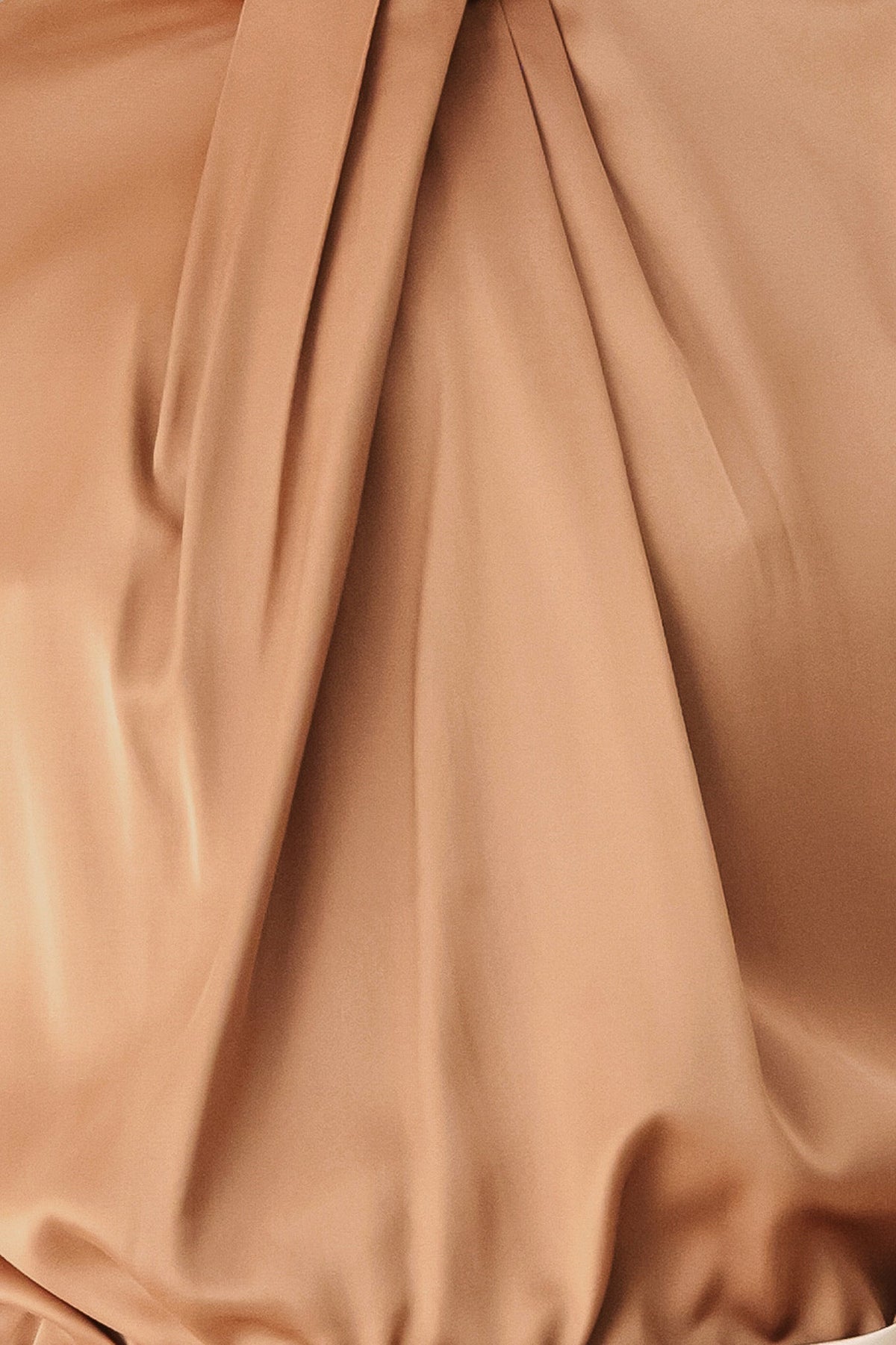 Bronze blouse fabric close-up with pleated panel and gathered neckline