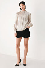 Champagne satin high-neck blouse with long puff sleeves and gathered cuffs