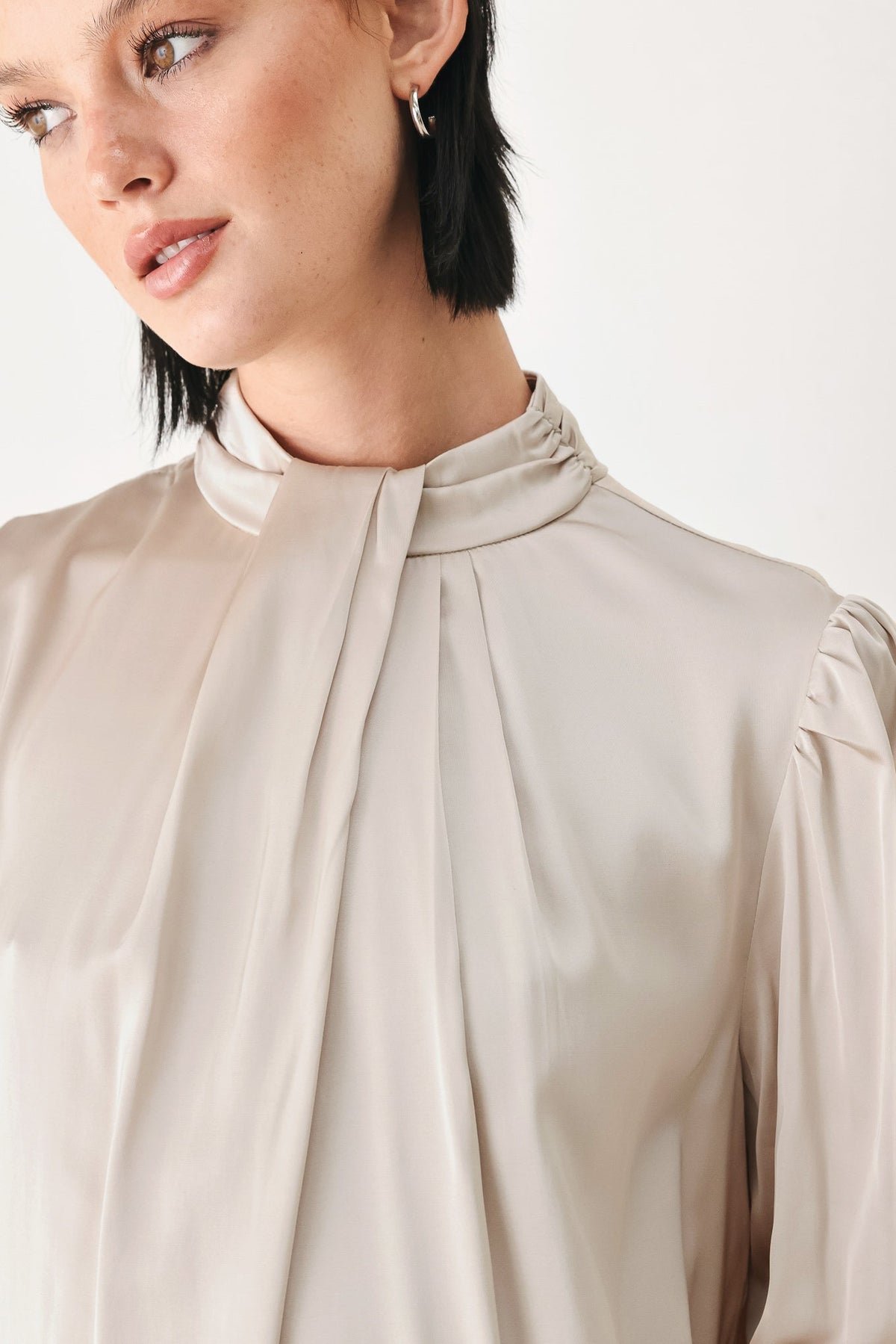 Champagne high-neck blouse with pleated tie neckline and soft puff sleeves