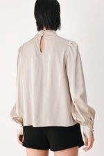 Champagne high-neck blouse with keyhole back opening and long puff sleeves