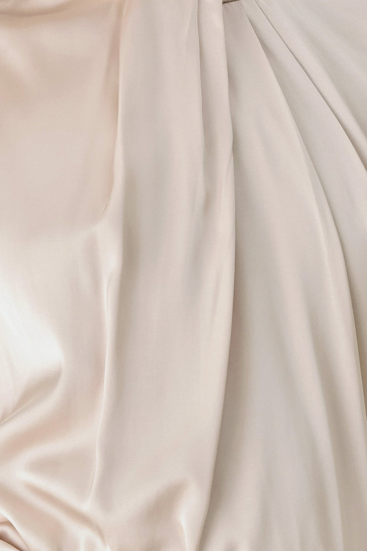 Champagne satin blouse fabric close-up with smooth sheen and soft drape