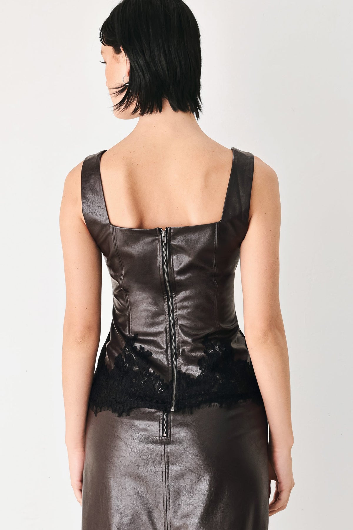 Dark brown faux leather top with center back seam and black lace back hem