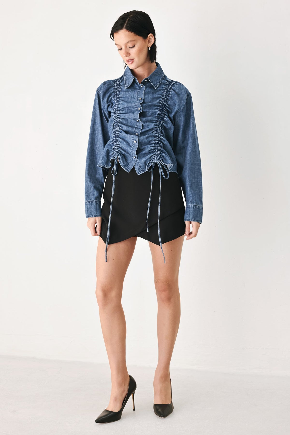 Indigo denim button-down top with gathered ruched front and drawstring hem ties