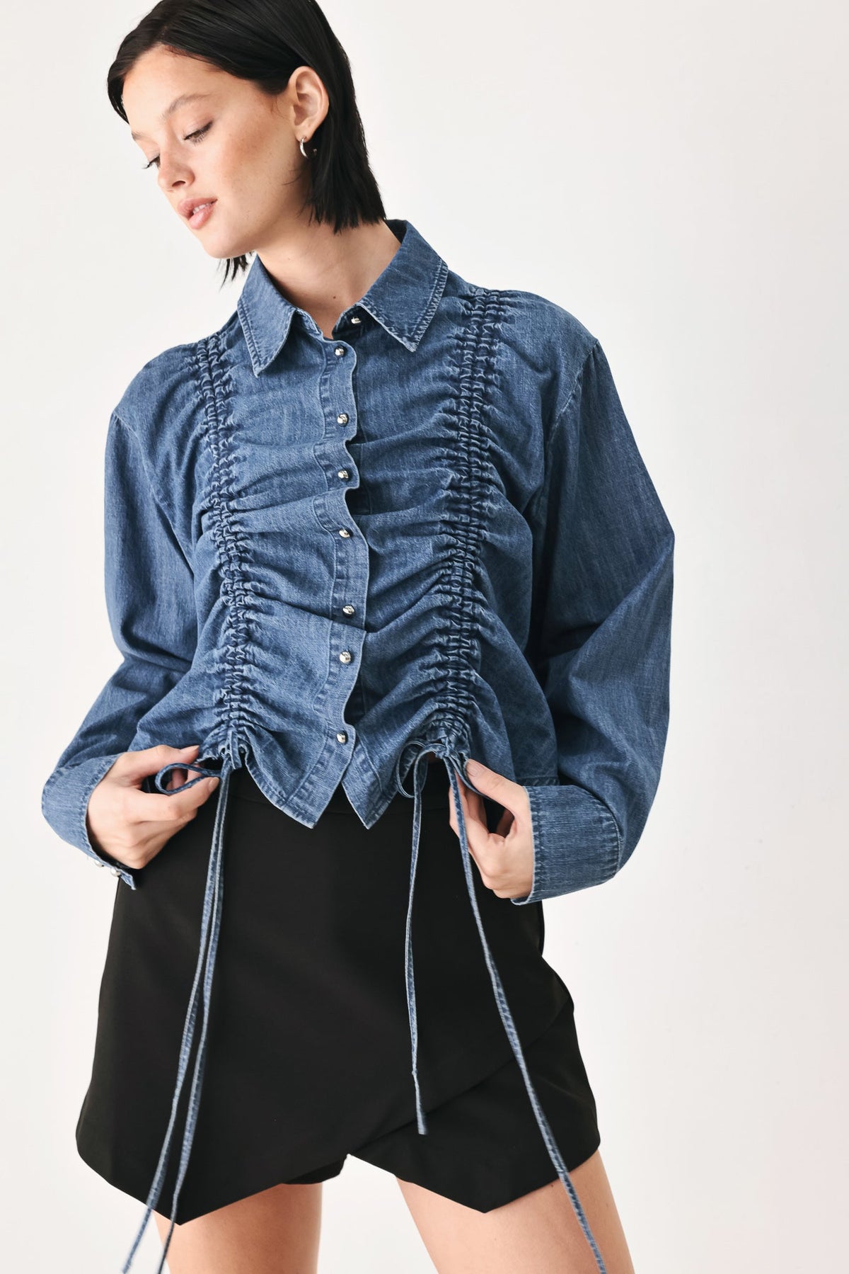 Indigo denim button-down top with ruched front, collar, and long sleeves