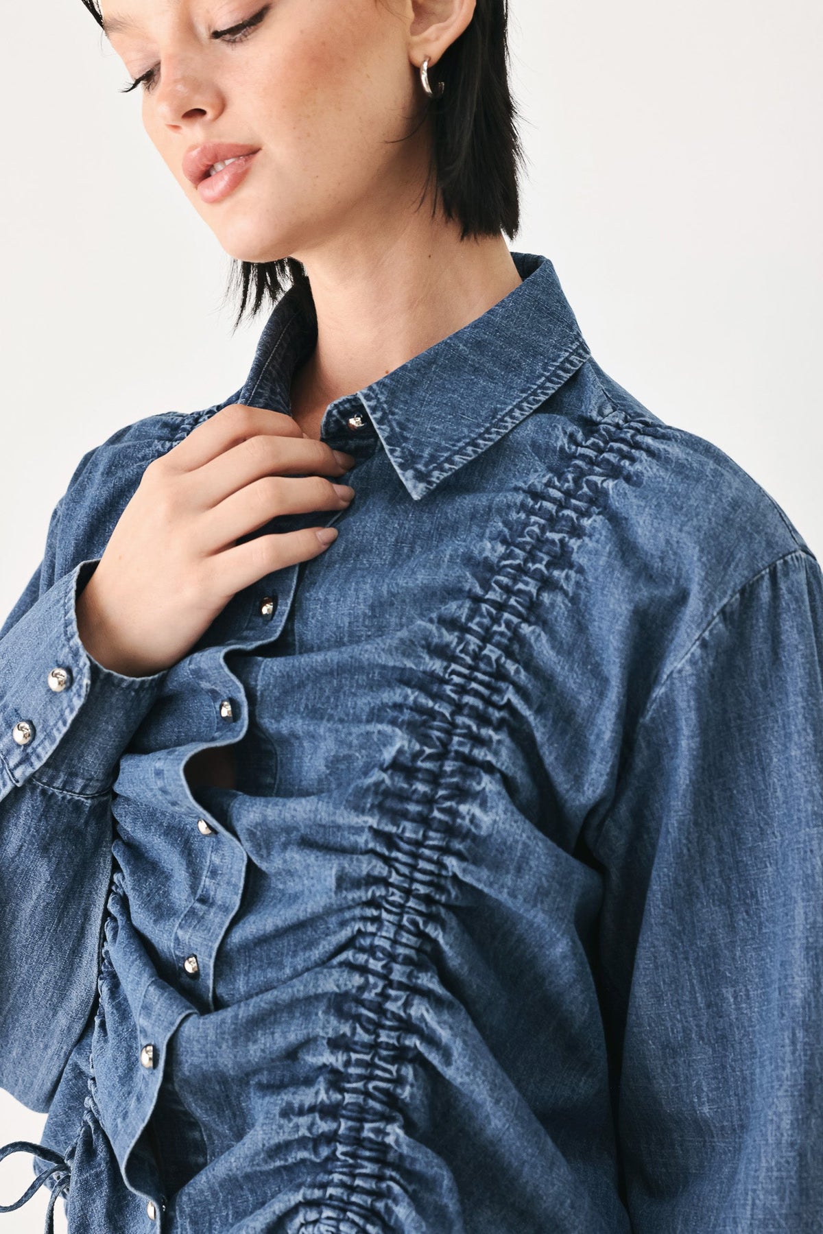 Indigo denim button-down top with ruched texture and front button placket detail