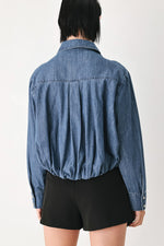 Indigo denim button-down top back view with curved yoke and long sleeves