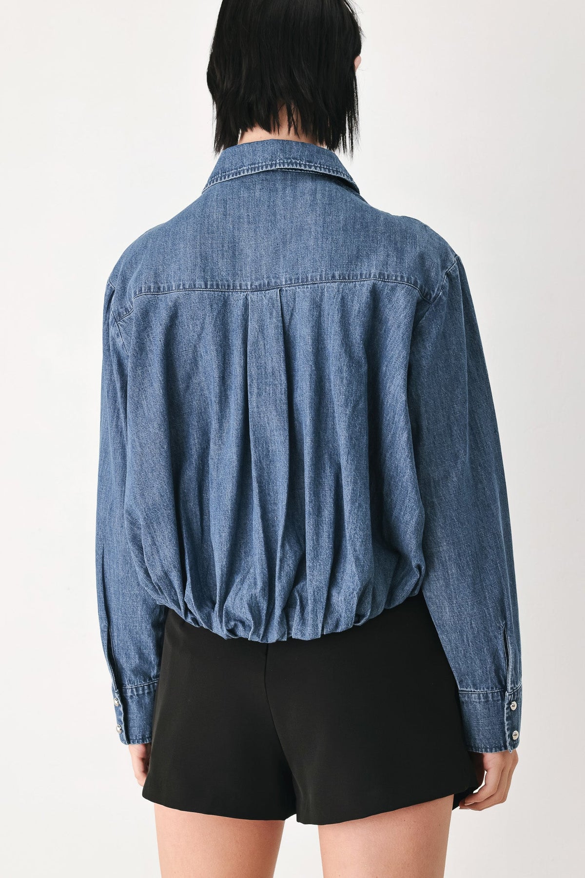 Indigo denim button-down top back view with curved yoke and long sleeves