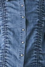 Indigo denim button placket with metal buttons and ruched textured side trim