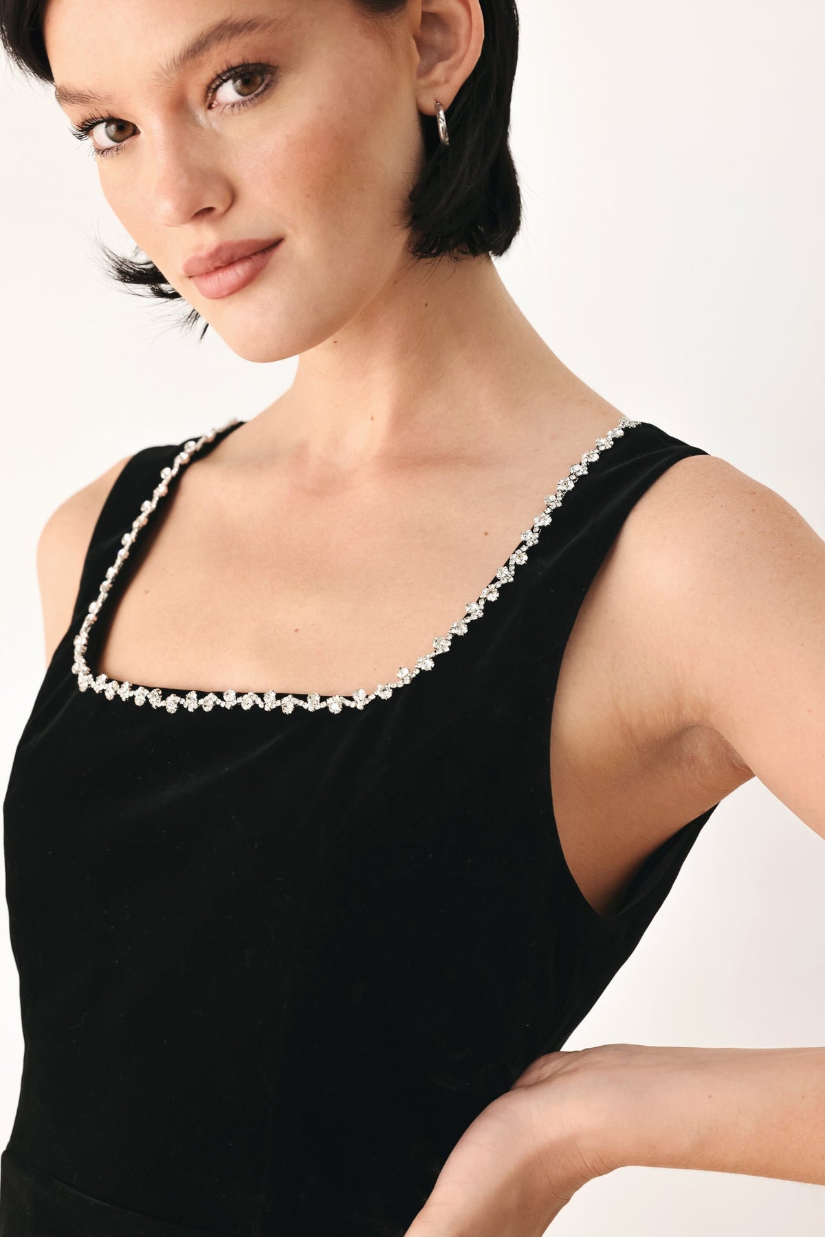 Black sleeveless velvet top with square neckline and jeweled embellishment trim