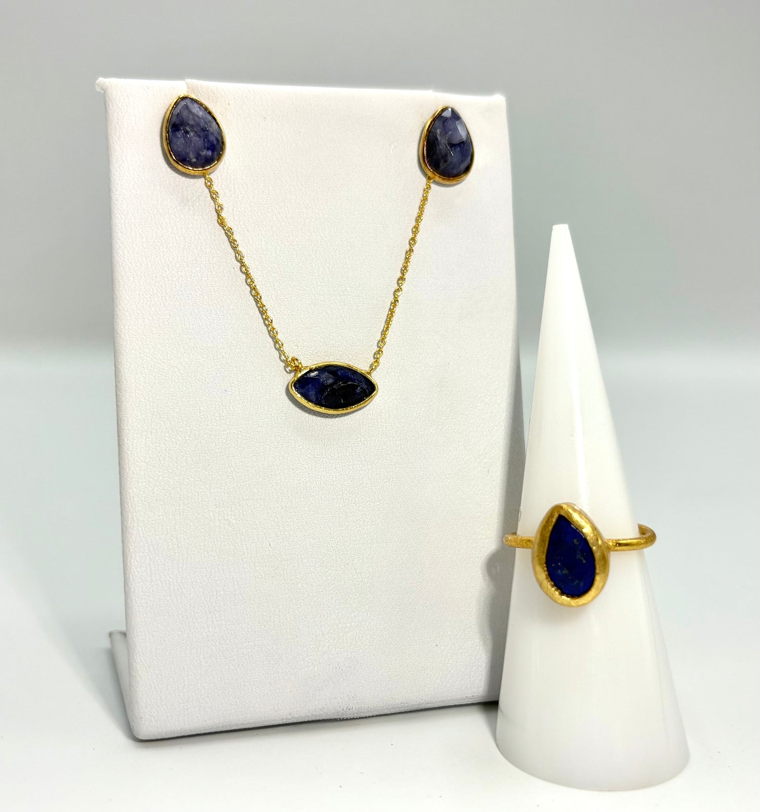 Gold-tone necklace and ring set with three dark blue oval lapis stones