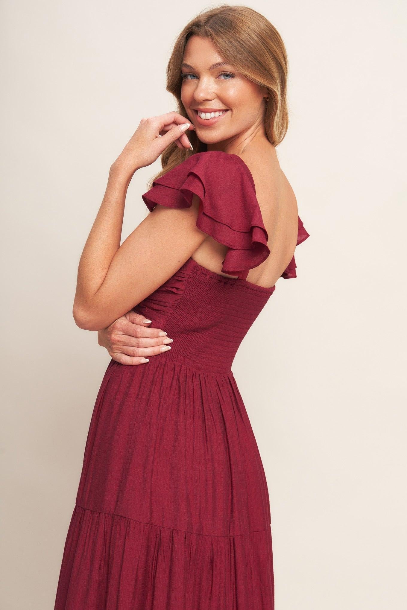 Deep red maxi dress, ruffled sleeves and ruched bodice, tiered skirt detail